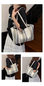 Lifestyle view of a large vertical striped canvas tote bag worn on shoulder for commuting
