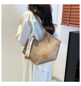 Detail of canvas tote bag with V-shaped opening and decorative woven ribbon detail