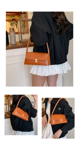 Chic caramel leather underarm bag featuring a vintage gold lock and minimalist style