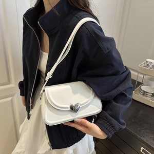 White leather crossbody bag with heart-shaped silver buckle and adjustable shoulder strap