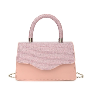 Pink crossbody square bag with sparkling sequin flap and round handle on white background