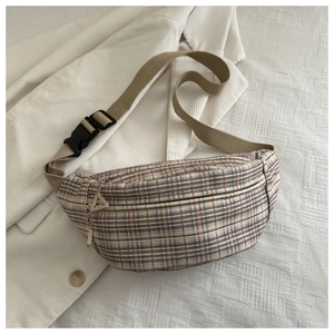 Detail view of vintage plaid chest bag with adjustable strap and durable zipper closure