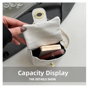 Detail showing internal capacity of white quilted mini bag with lipstick and powder compact