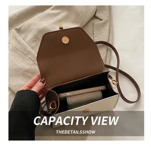 Interior view of small square crossbody bag showing capacity for phone and wallet