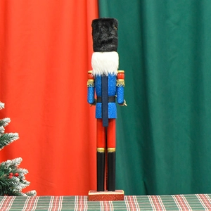 Rear view of a 55cm wooden nutcracker soldier in blue glitter uniform for Christmas