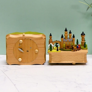 Handcrafted wooden music box with a miniature castle and mechanical wind-up base mechanism