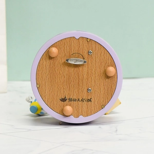 Mechanical wooden carousel music box base with purple casing and metal wind-up key