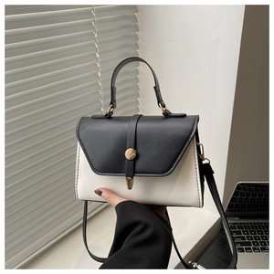Detail of contrast color crossbody bag with gold buckle and smooth PU leather texture