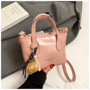 Pink glossy tote bag detail with creative ball pendant and Fashion & Bags text logo