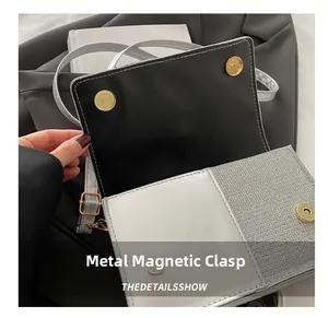 Detail of silver flap handbag featuring a secure metal magnetic snap button closure