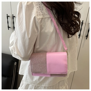 Detailed back view of pink crossbody bag with glitter and smooth leather finish