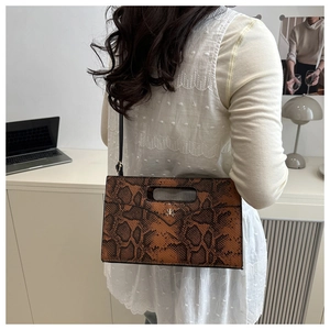 Detail of brown python print rectangular tote bag with metal logo and slim shoulder strap