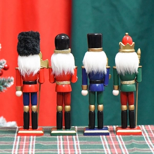 Set of four 18cm wooden nutcracker soldiers in blue and green uniforms seen from the back
