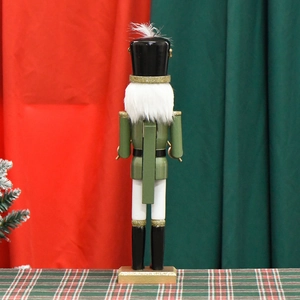 Classic green wooden nutcracker soldier back view on a festive Christmas background