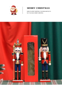 Macro view of two 30cm wooden nutcracker soldiers in a red window gift box packaging