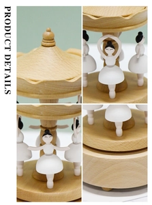 Detailed close-up of wooden ballet music box featuring carved dancers and natural grain