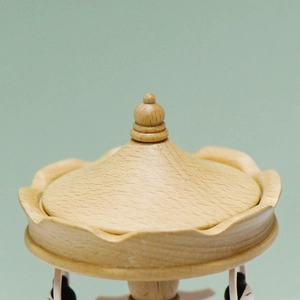 European wooden ballet music box with wavy carving detail and natural wood grain