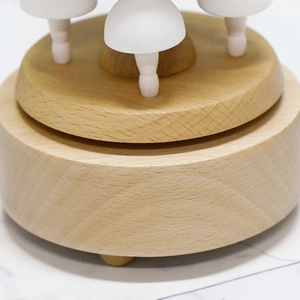 European wooden ballet music box with natural wood grain and layered round base design