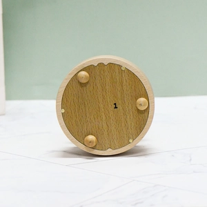 European style creative wooden ballet music box with a minimalist round base and light wood grain