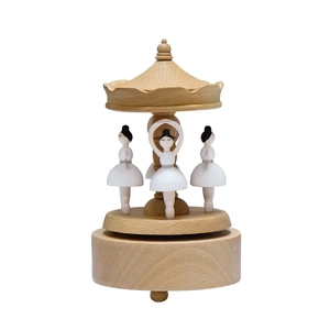 Handcrafted wooden ballerina music box featuring three rotating dancers in a classic carousel style
