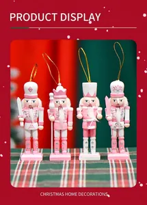 Detailed set of four pink and white wooden nutcracker soldier ornaments with gold hanging ropes