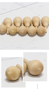 Detailed view of unfinished smooth wooden peg parts and natural drop-shaped craft accessories