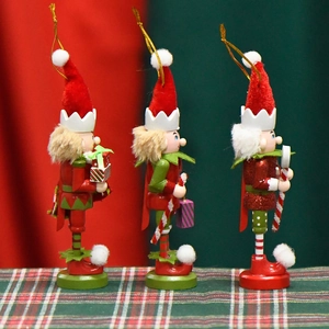 Three 13cm wooden Christmas nutcracker elf ornaments with festive red and green hanging ropes