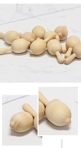 Detailed macro view of unfinished natural wood baby rattle shakers for DIY crafts