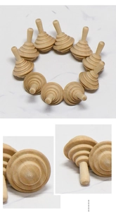 Detailed view of DIY unpainted natural wood spinning tops with smooth texture