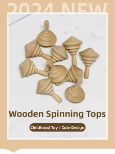 Unfinished wooden spinning tops on marble background for DIY painting and kids crafts