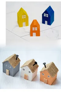 Detail of DIY wooden houses showing smooth painted styles and rustic designs with burlap roofs