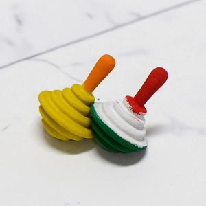 Colorful spinning top toys for DIY painting on white marble surface background