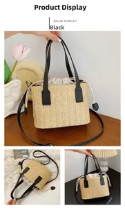 Detailed view of woven straw bucket bag with black leather handle and drawstring pouch