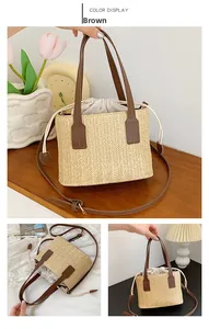 Detail of woven straw tote bag featuring brown leather handles and drawstring inner liner