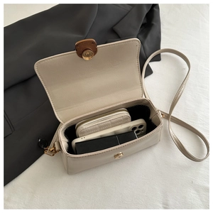 Close-up of the vintage beige crossbody bag interior with phone and wallet storage