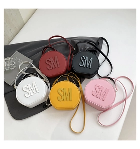 Detailed arrangement of stylish round leather handbags in five vibrant colors with SM logo