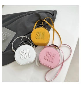 Three candy-colored round mini handbags with SM embossed logo and top handles