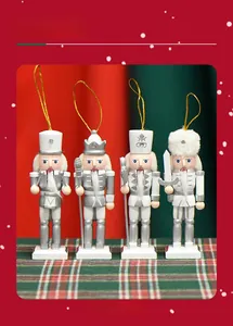 Detailed view of four white and silver wooden nutcracker ornaments on plaid background