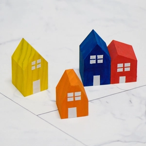 DIY colorful wooden house ornaments on marble surface for creative home decor and kids crafts