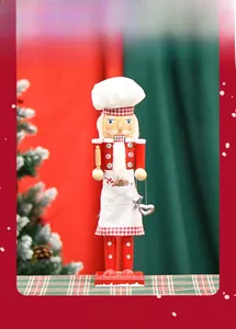 Detail of 38cm wooden chef nutcracker with red white apron holding a rolling pin