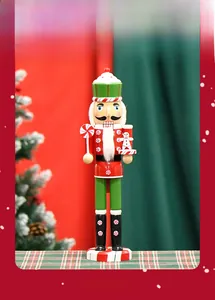 Macro detail of wooden nutcracker soldier holding gingerbread man and mint candy