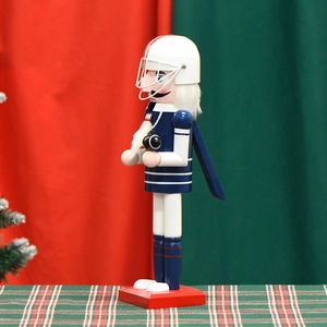Casse-noisette joueur de football américain 36cm en uniforme bleu sur fond de Noël