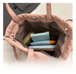 Interior view of pink drawstring bag with pearl trim showing storage space for daily items