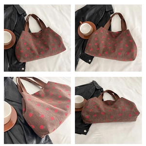 Detail view of brown corduroy tote bag with red strawberry embroidery from multiple angles