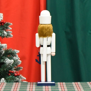Back view of 38cm wooden sailor nutcracker with white uniform and blue anchor accessory