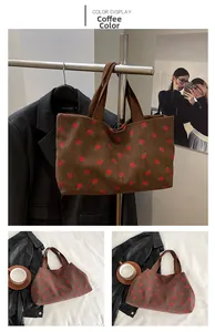 Detailed close-up of brown corduroy tote bag with vibrant red strawberry print patterns