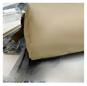 Detail shot of premium beige water-resistant nylon fabric with durable green webbing strap