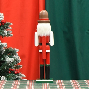Rear view of 38cm wooden brewer nutcracker soldier ornament with festive red and green background