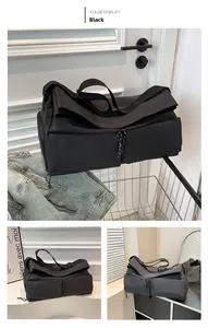 Detail of black utility travel bag with functional pockets and adjustable nylon strap