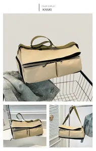 Detail view of khaki travel bag showing adjustable olive straps and zipper pockets